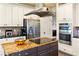Spacious kitchen with stainless steel appliances, a center island with cooktop, and granite countertops at 5105 Riverthur Pl, Duluth, GA 30096