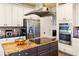 Modern kitchen with stainless steel appliances, granite countertops, and white cabinets at 5105 Riverthur Pl, Duluth, GA 30096