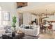 Open-concept living room showcasing the sofa, kitchen with stainless steel appliances, and breakfast nook at 5105 Riverthur Pl, Duluth, GA 30096