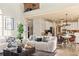 Open-concept living room with hardwood floors, high ceilings, and seamless flow into modern kitchen at 5105 Riverthur Pl, Duluth, GA 30096