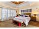 Cozy main bedroom featuring a tray ceiling, plush carpet, and abundant natural light at 5105 Riverthur Pl, Duluth, GA 30096