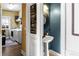 Charming powder room with pedestal sink, unique mirror, and adjacent laundry room at 5105 Riverthur Pl, Duluth, GA 30096