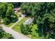 Aerial view of a house with a long driveway surrounded by trees and a yard at 1054 Hillcrest Se Dr, Atlanta, GA 30316