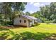 Exterior view of the house, surrounded by green grass and shady trees at 1054 Hillcrest Se Dr, Atlanta, GA 30316