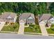 Aerial view of three homes in a suburban neighborhood with mature trees and landscaped yards at 1087 Halletts Peak Pl, Lawrenceville, GA 30044