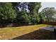 Large backyard with a wood fence, grass, and mature trees at 1087 Halletts Peak Pl, Lawrenceville, GA 30044