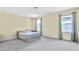 Spacious bedroom with neutral carpet, two windows with curtains, and a bed at 1087 Halletts Peak Pl, Lawrenceville, GA 30044