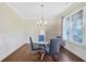 Bright dining room featuring hardwood floors, a glass table, and wainscoting at 1087 Halletts Peak Pl, Lawrenceville, GA 30044