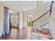 Entryway featuring a staircase, hardwood floors, and a view into adjacent rooms at 1087 Halletts Peak Pl, Lawrenceville, GA 30044