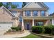 Beautiful two-story brick home with blue shutters, landscaped front yard, and covered entry at 1087 Halletts Peak Pl, Lawrenceville, GA 30044