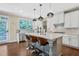 Stylish kitchen with modern appliances, sleek white cabinetry, and a large center island at 1087 Halletts Peak Pl, Lawrenceville, GA 30044