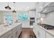 Modern kitchen featuring quartz countertops, stainless steel appliances, and modern lighting at 1087 Halletts Peak Pl, Lawrenceville, GA 30044