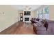 Living room showcasing a cozy fireplace, hardwood floors, and a comfortable couch at 1087 Halletts Peak Pl, Lawrenceville, GA 30044