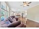 Open concept living space with hardwood floors, natural light, and a comfortable couch at 1087 Halletts Peak Pl, Lawrenceville, GA 30044