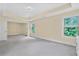 Spacious main bedroom with tray ceiling, carpet, and multiple windows allowing natural light at 1087 Halletts Peak Pl, Lawrenceville, GA 30044