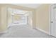 Spacious main bedroom with tray ceiling, carpet, and a view into the sitting room at 1087 Halletts Peak Pl, Lawrenceville, GA 30044