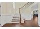 Open staircase with hardwood floors leading to the upper level, adjacent to the entryway at 1087 Halletts Peak Pl, Lawrenceville, GA 30044
