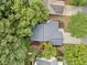 Aerial view of house with landscaped backyard, mature trees, and a driveway leading to the home at 172 Stoneforest Dr, Woodstock, GA 30189