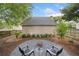 Backyard featuring a fire pit area, well-maintained landscaping, and a charming, private outdoor space at 172 Stoneforest Dr, Woodstock, GA 30189