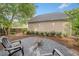 Charming backyard fire pit area with gravel base and seating, complemented by manicured landscaping at 172 Stoneforest Dr, Woodstock, GA 30189