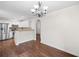 Charming dining area with kitchen access, chandelier, and laminate flooring at 172 Stoneforest Dr, Woodstock, GA 30189