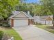 Inviting home with brick accents, a spacious driveway and attached two car garage at 172 Stoneforest Dr, Woodstock, GA 30189