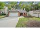 Charming brick home featuring a well-manicured lawn and attached two car garage at 172 Stoneforest Dr, Woodstock, GA 30189