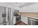 Bright kitchen features stainless steel appliances and white cabinets at 172 Stoneforest Dr, Woodstock, GA 30189