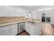 Kitchen with stainless steel appliances, granite countertops, and access to the patio at 172 Stoneforest Dr, Woodstock, GA 30189