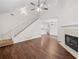 Open-concept living room with laminate flooring, fireplace, and staircase at 172 Stoneforest Dr, Woodstock, GA 30189