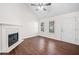 Bright living room featuring laminate floors, a fireplace, and large windows at 172 Stoneforest Dr, Woodstock, GA 30189