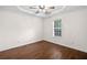 Main bedroom featuring a window, ceiling fan, and hardwood floors at 172 Stoneforest Dr, Woodstock, GA 30189