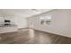 Sunlit living room with hardwood floors, modern appliances, and access to a patio at 1910 Van Allen Ct, Dacula, GA 30019