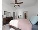 Bedroom features neutral carpet, a ceiling fan, and a dresser with mirror at 852 Constellation Dr, Decatur, GA 30033