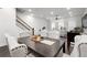 Elegant dining room with stylish seating, a modern light fixture, and an open view of the living space at 852 Constellation Dr, Decatur, GA 30033