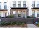Inviting townhome featuring brick accents, a covered entryway, and a fenced patio with landscaping at 852 Constellation Dr, Decatur, GA 30033