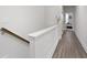 Hallway with hardwood floors featuring a staircase and doors to the bedrooms at 852 Constellation Dr, Decatur, GA 30033