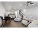 Open concept living room boasts a hardwood floor, white sofa, dining area and a staircase at 852 Constellation Dr, Decatur, GA 30033