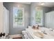 Bright bathroom featuring a large mirror, white countertops, and a walk-in shower at 1054 Foreststone Sw Way, Marietta, GA 30064