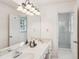 Bright bathroom featuring a double vanity, large mirror and glass-enclosed shower at 1054 Foreststone Sw Way, Marietta, GA 30064
