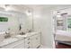 Bathroom vanity with double sinks and marble countertop, open to the bedroom at 1054 Foreststone Sw Way, Marietta, GA 30064
