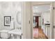 Hallway view of half bath, with kitchen beyond, featuring decorative red barn door at 1054 Foreststone Sw Way, Marietta, GA 30064