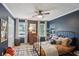 Bedroom with a metal bed frame, dark walls and large windows at 1054 Foreststone Sw Way, Marietta, GA 30064