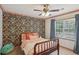 Bedroom featuring floral wallpaper, a metal bed frame, and large windows at 1054 Foreststone Sw Way, Marietta, GA 30064
