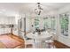 Eat-in kitchen area with stainless steel refrigerator, custom cabinets, and sunlit windows at 1054 Foreststone Sw Way, Marietta, GA 30064