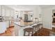 Kitchen island with granite countertops, stainless appliances, and a view into the living room at 1054 Foreststone Sw Way, Marietta, GA 30064