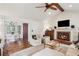 Open-concept living room with hardwood floors, fireplace, and seamless flow to dining area at 1054 Foreststone Sw Way, Marietta, GA 30064