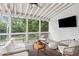 Relaxing screened porch featuring a ceiling fan and comfortable seating arrangement at 1054 Foreststone Sw Way, Marietta, GA 30064