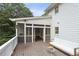 Exterior angle of screened porch with white sofas and wood decking at 1054 Foreststone Sw Way, Marietta, GA 30064