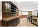 Finished basement bar with tiled countertops, wine storage, seating and an outside view at 3260 Governors Court Ct, Duluth, GA 30096